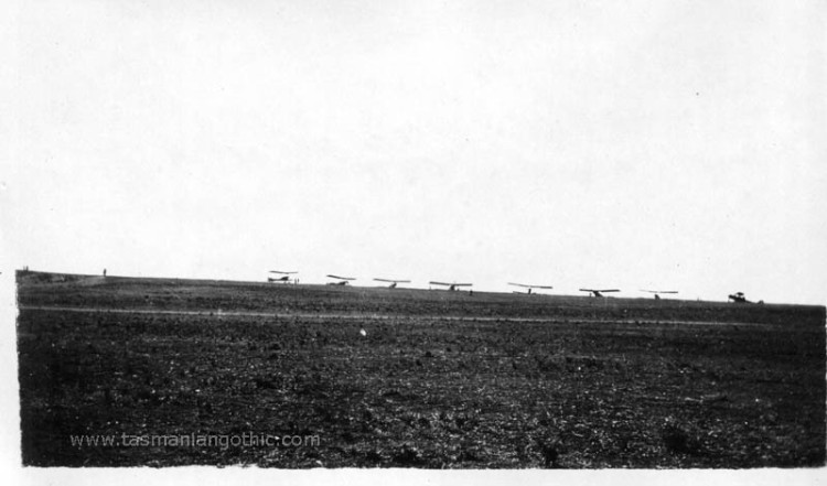 biplanes silhouetted on horizon